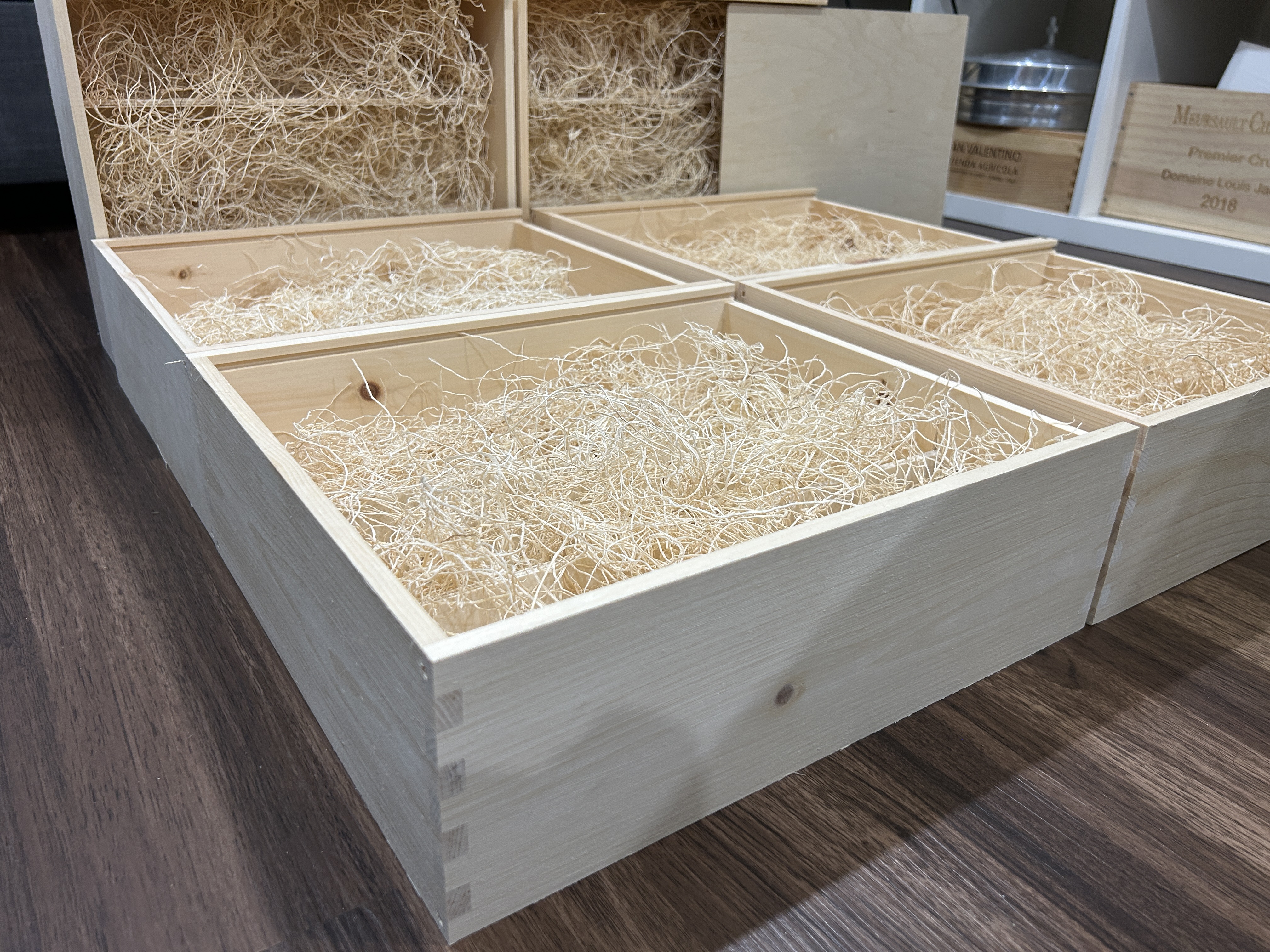 Handcrafted wooden gift boxes with compartments and natural packing material